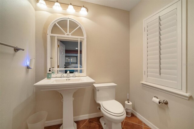 825 Islebay Dr, Apollo Beach, FL 33572 - bathroom with baseboards, toilet, and tile patterned flooring
