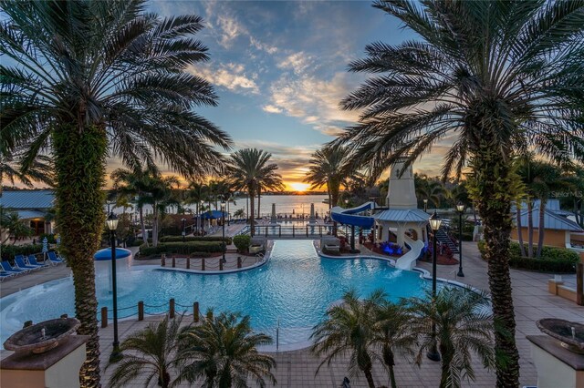 825 Islebay Dr, Apollo Beach, FL 33572 - pool at dusk featuring a community pool and a water slide