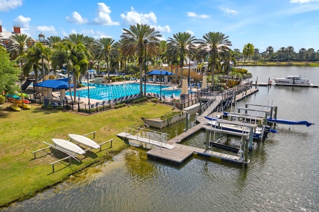 dock area with a community pool, a water view, a yard, and a patio area