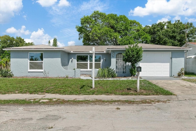 ranch-style home featuring a garage and a front lawn