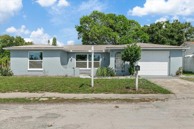 ranch-style home featuring driveway, a front lawn, an attached garage, and stucco siding