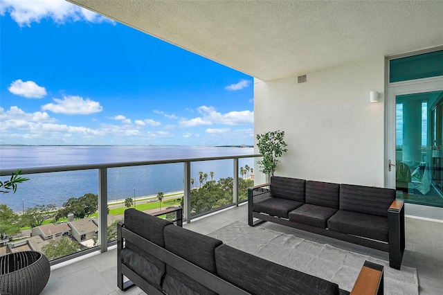 balcony featuring a water view and an outdoor hangout area