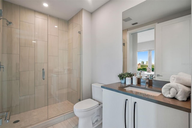 bathroom featuring walk in shower, toilet, and vanity