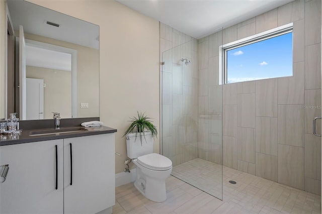 bathroom with vanity, toilet, and a shower with door