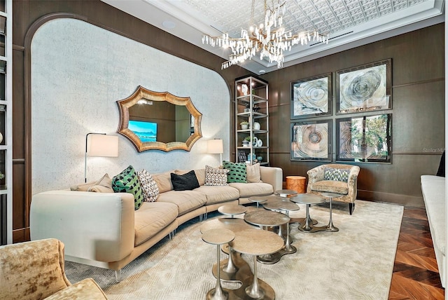 living room featuring a chandelier and parquet floors