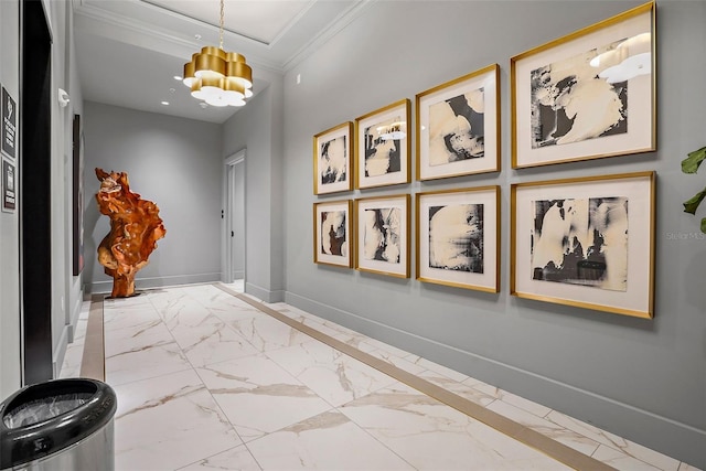 hall featuring crown molding and a notable chandelier