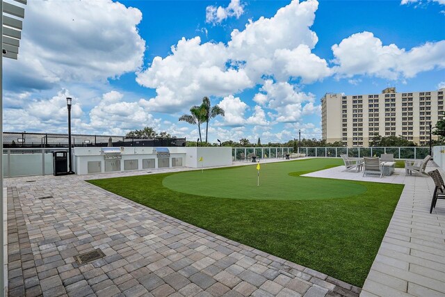 view of community with an outdoor kitchen and a patio