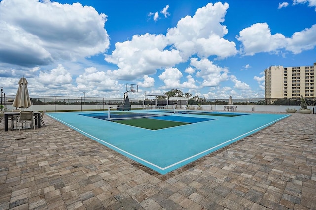 view of swimming pool with tennis court