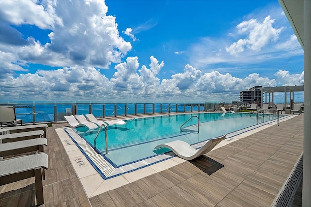 view of swimming pool featuring a water view