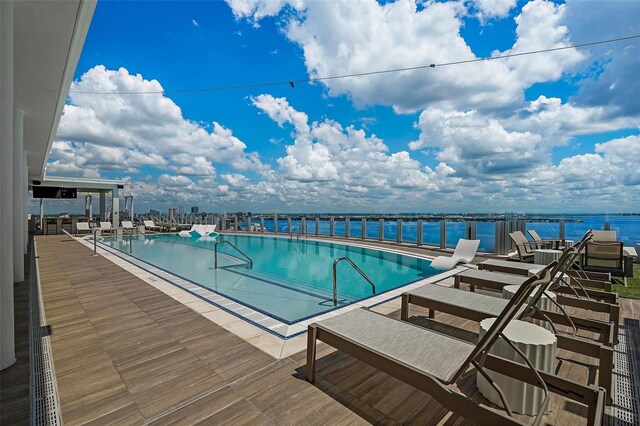 view of swimming pool with a water view