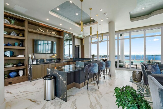 bar featuring pendant lighting, expansive windows, and a tray ceiling