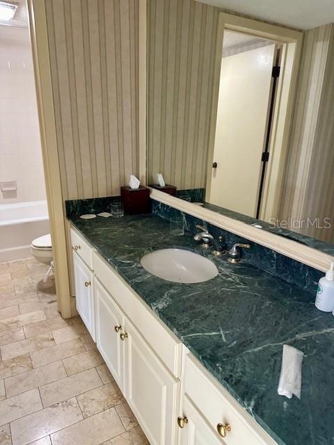 full bathroom with vanity, toilet, and plus walk in shower