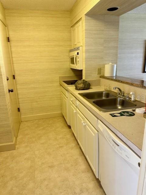 kitchen featuring white cabinetry, white appliances, and sink