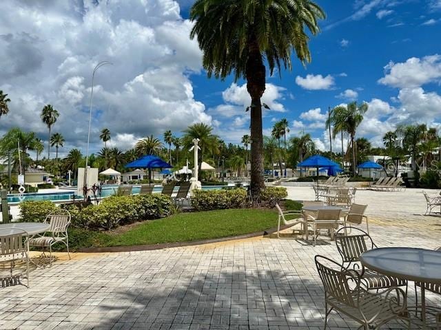 view of property's community with a yard and a patio area