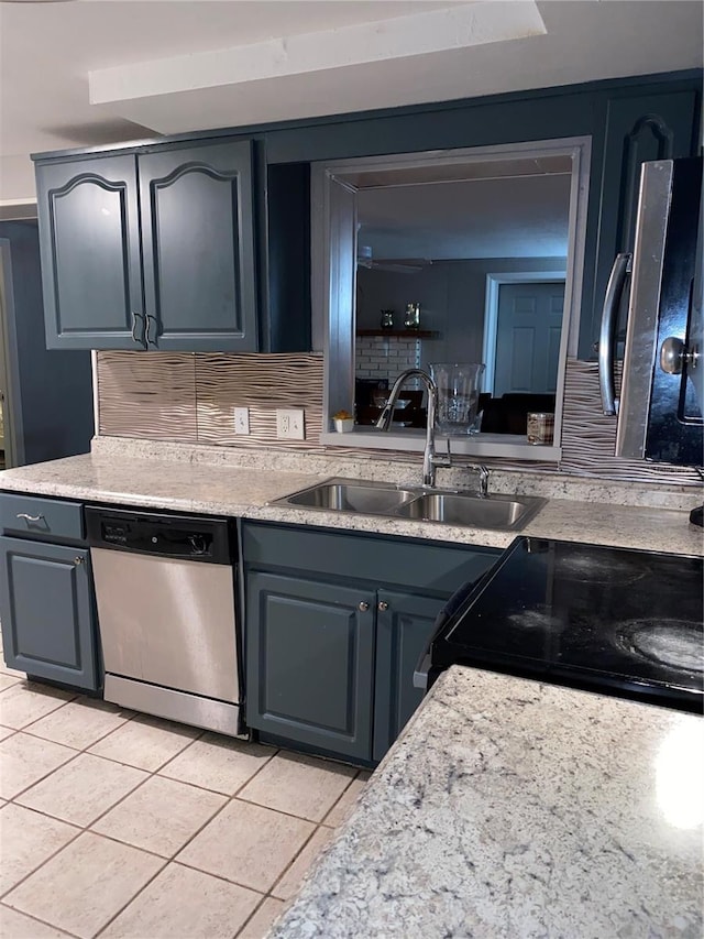 kitchen with sink, light tile patterned floors, stainless steel dishwasher, decorative backsplash, and black range