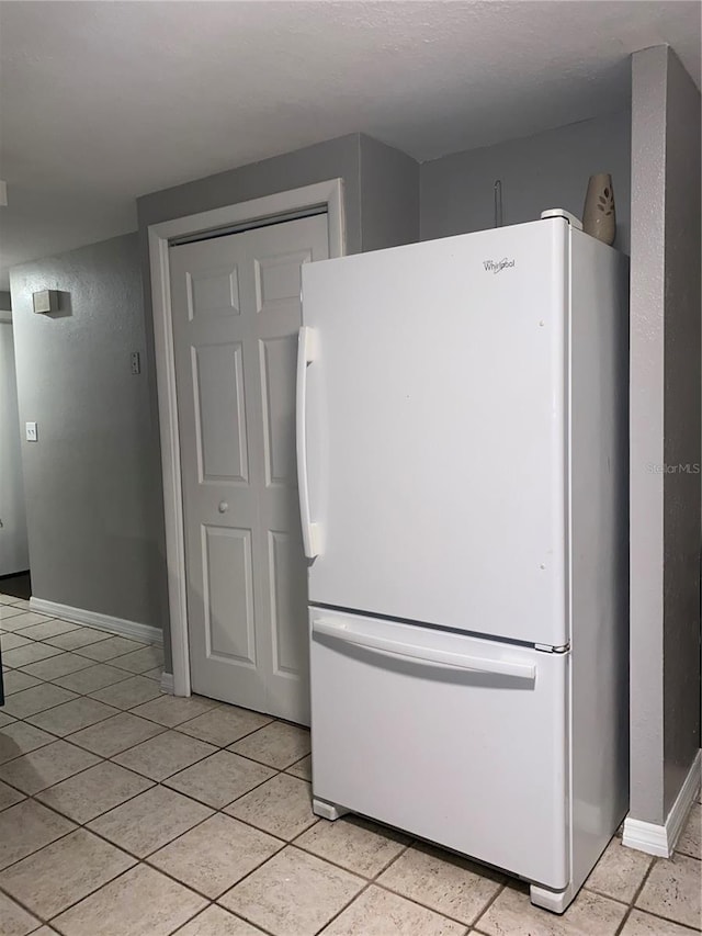 kitchen with white refrigerator and light tile patterned floors