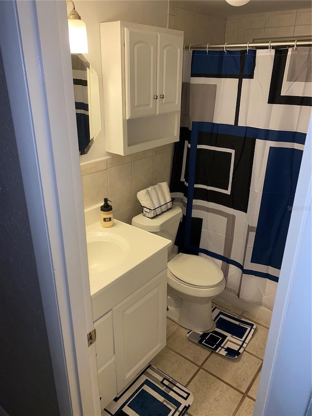 6115 7th Ave, New Port Richey, FL 34653 - full bathroom with vanity, toilet, tile walls, a shower with shower curtain, and tasteful backsplash