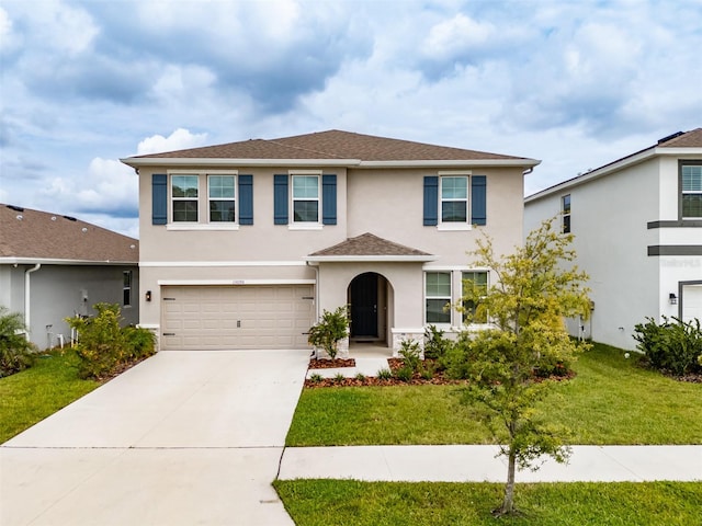 view of front of house with a garage and a front lawn