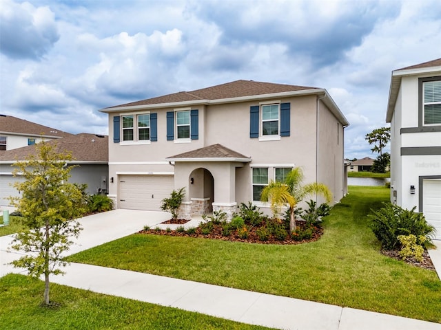 view of front of property featuring a front lawn and a garage