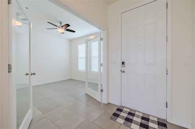 foyer featuring ceiling fan and light tile patterned floors