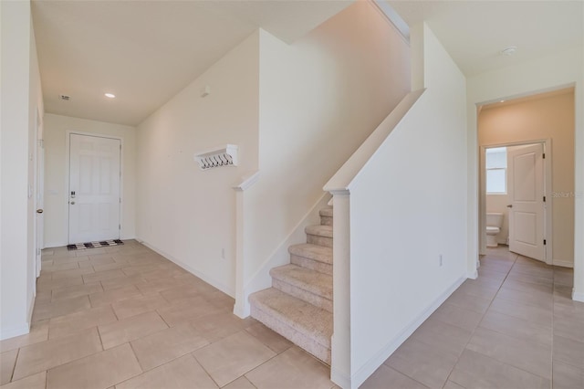 staircase featuring tile patterned flooring