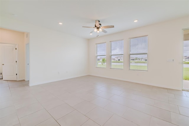 unfurnished room featuring ceiling fan and light tile patterned floors