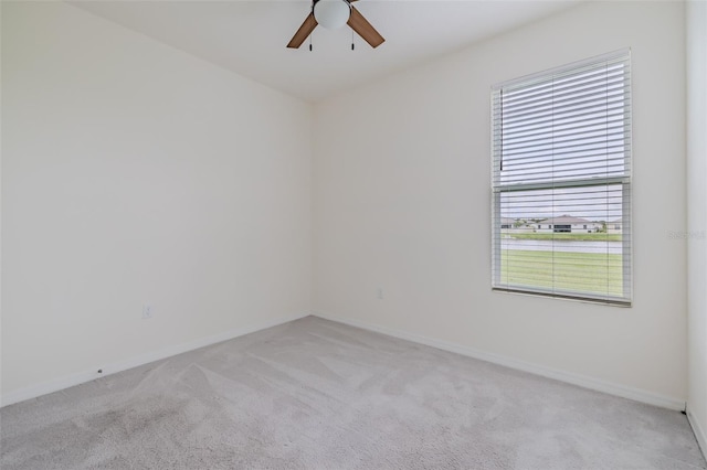 unfurnished room with ceiling fan and light colored carpet