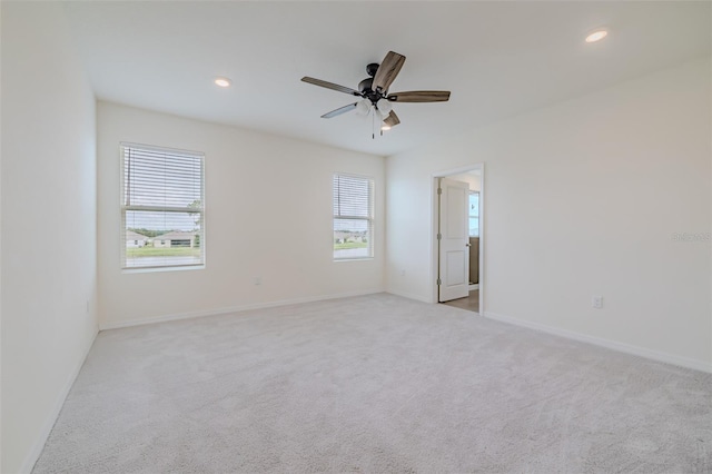 unfurnished room featuring light colored carpet and ceiling fan