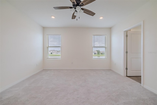 carpeted empty room with plenty of natural light and ceiling fan