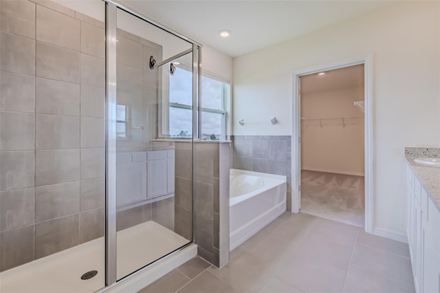 bathroom with vanity, independent shower and bath, and tile patterned floors