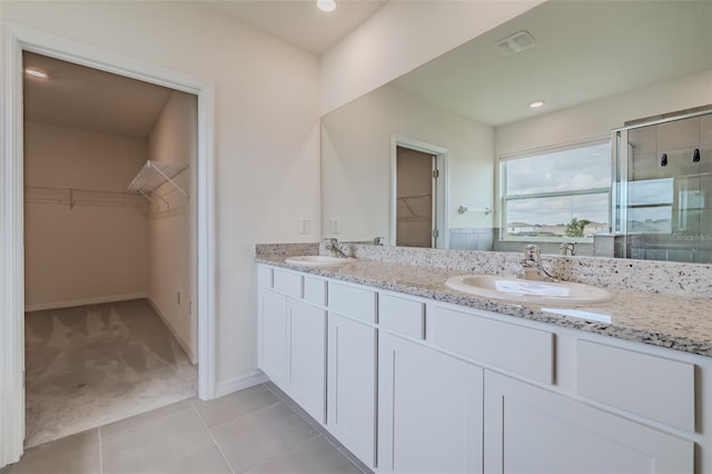 bathroom featuring vanity, an enclosed shower, and tile patterned floors