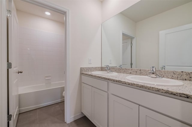 full bathroom with vanity, toilet, tile patterned floors, and washtub / shower combination