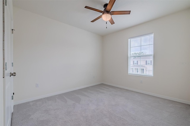 empty room featuring light carpet and ceiling fan