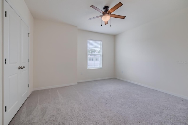 carpeted empty room featuring ceiling fan