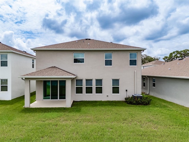 rear view of property featuring a yard and a patio