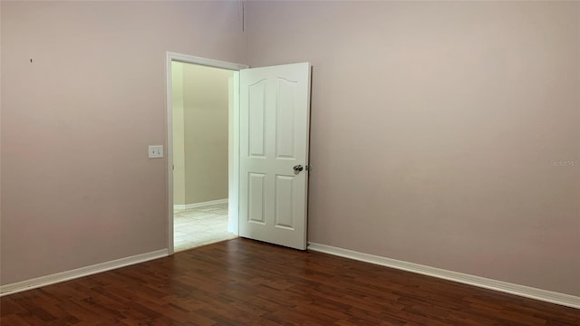 unfurnished room featuring dark wood-type flooring