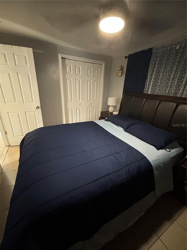 tiled bedroom with a closet and ceiling fan