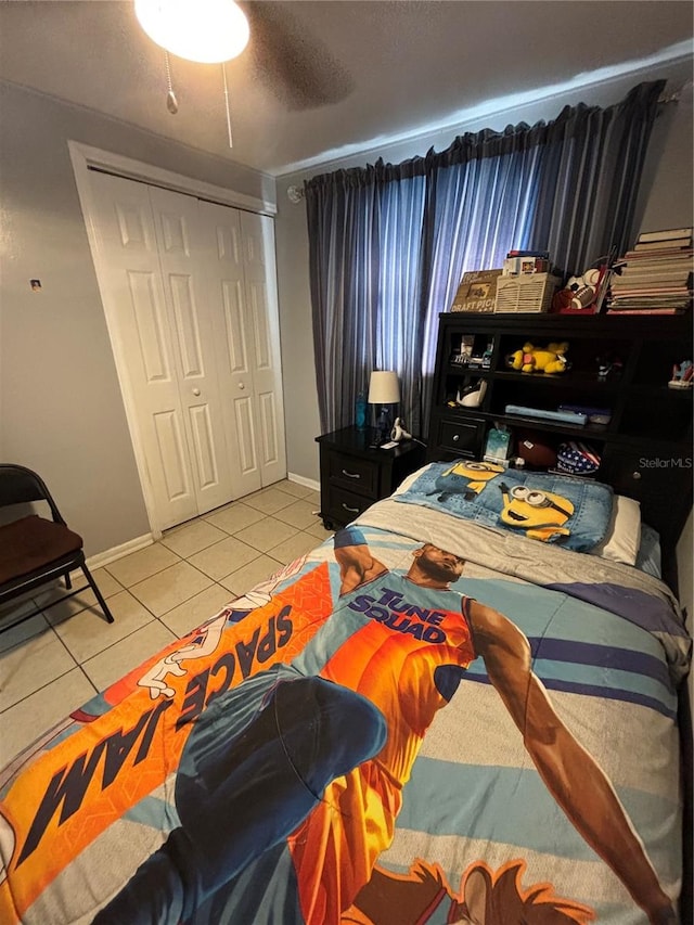 bedroom with a textured ceiling, light tile patterned flooring, and a closet