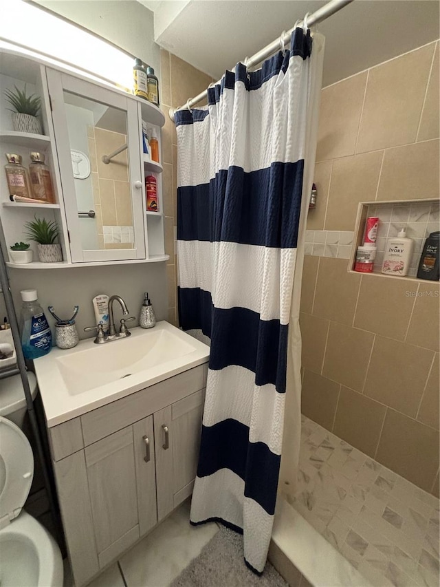 bathroom featuring vanity and curtained shower