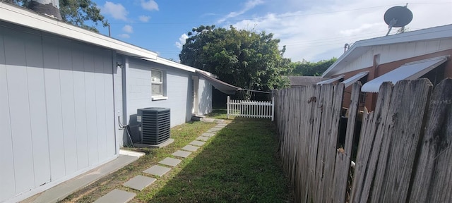 view of yard featuring central air condition unit