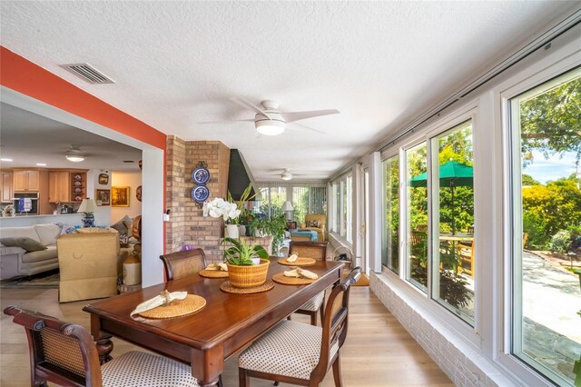 sunroom featuring ceiling fan