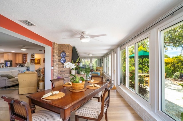 sunroom / solarium featuring visible vents and ceiling fan