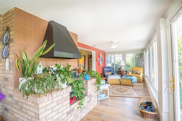 sunroom / solarium featuring ceiling fan and plenty of natural light