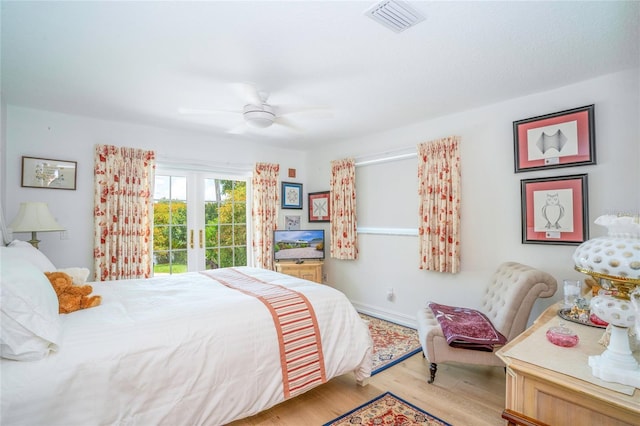 bedroom with visible vents, baseboards, ceiling fan, light wood-style flooring, and french doors