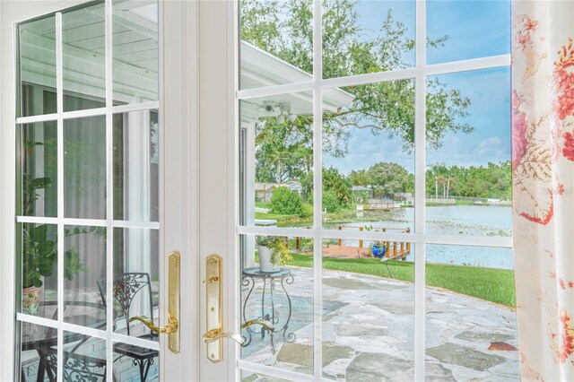 doorway with a water view and a healthy amount of sunlight