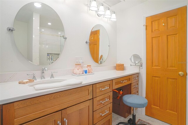 bathroom with vanity, a shower, and tile patterned floors