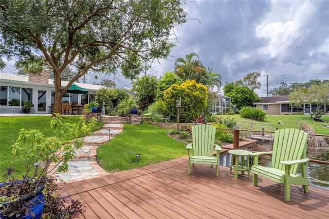 deck featuring a lanai and a yard