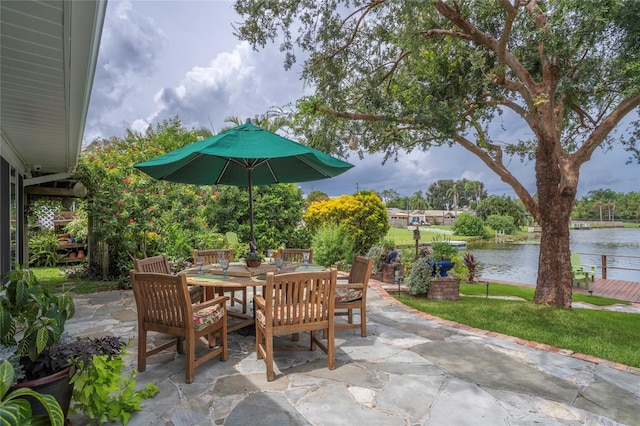 view of patio / terrace featuring outdoor dining space and a water view