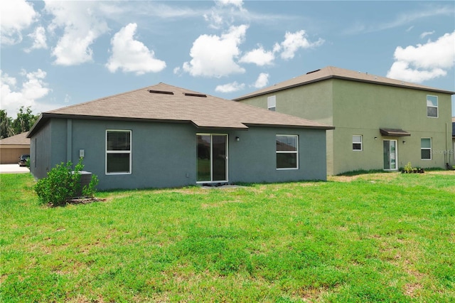 rear view of house with a lawn