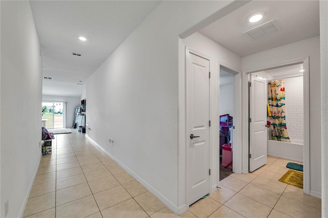 hall featuring light tile patterned flooring